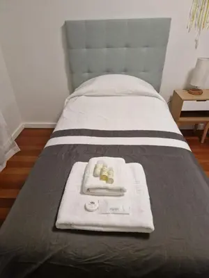 a bed with a tray of towels on it at Cristinas 2 Bedroom Apartment Caniço in Caniço