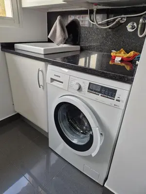 a washing machine in a kitchen with a counter at Cristinas 2 Bedroom Apartment Caniço in Caniço