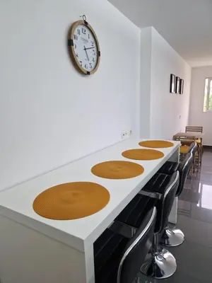 a room with a counter with a clock on the wall at Cristinas 2 Bedroom Apartment Caniço in Caniço