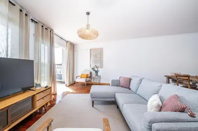 a living room with a couch and a flat screen tv at Pateo do Carmo - By Wehost in Funchal