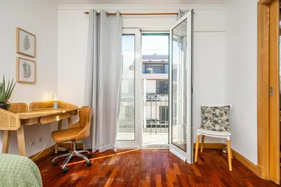 a bedroom with a desk and a chair and a window at Pateo do Carmo - By Wehost in Funchal