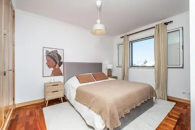 a white bedroom with a bed and a window at Pateo do Carmo - By Wehost in Funchal