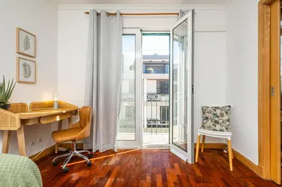 a bedroom with a desk and a chair and a window at Pateo do Carmo - By Wehost in Funchal
