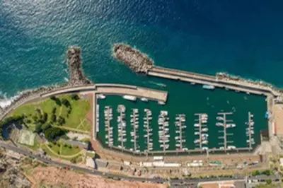 an aerial view of a marina next to the water at Marina View Apartment - Pool & stunning ocean view in Calheta