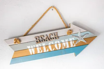 a wooden sign with seashells and a starfish at Bay View Townhouse in Salema