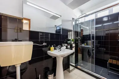 a bathroom with a sink and a shower at Bay View Townhouse in Salema