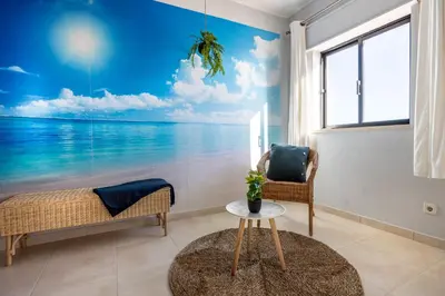 a living room with a view of the ocean at Bay View Townhouse in Salema