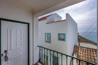 a stairway with a white door and a view of the ocean at Villa som das Ondas in Budens