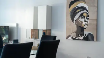 a painting of a woman hanging on a wall at Deluxe Living by LovelyStay in Funchal