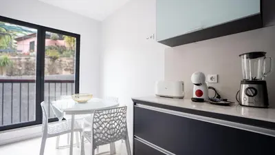 a kitchen with a counter and a table with a blender at Deluxe Living by LovelyStay in Funchal