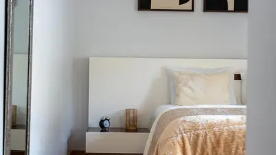 a white bedroom with a bed and a mirror at Deluxe Living by LovelyStay in Funchal