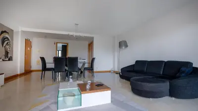 a living room with a black couch and a table at Deluxe Living by LovelyStay in Funchal