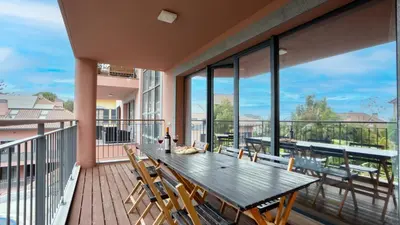 a large deck with a wooden table and chairs at Deluxe Living by LovelyStay in Funchal