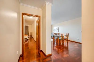 a hallway with a dining room and a dining table at Apartamento Vista Azul in Funchal