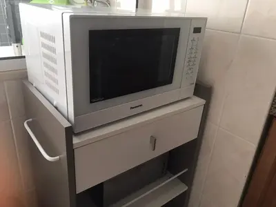 a microwave sitting on top of a dresser at Apartamento Vista Azul in Funchal