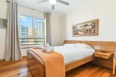 a bedroom with a bed and a large window at Monumental Ocean View by Atlantic Holiday in Funchal
