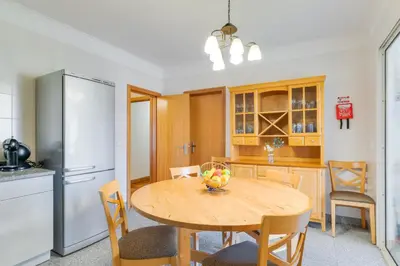a kitchen with a wooden table and a refrigerator at Monumental Ocean View by Atlantic Holiday in Funchal