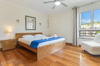 a bedroom with a bed with two stuffed animals on it at Monumental Ocean View by Atlantic Holiday in Funchal