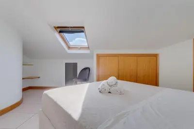 a bedroom with a bed with towels on it at Camara de Lobos Duplex Apartment by Holiday Rental Madeira in Câmara de Lobos