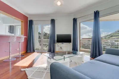 a living room with a couch and a tv at Camara de Lobos Duplex Apartment by Holiday Rental Madeira in Câmara de Lobos