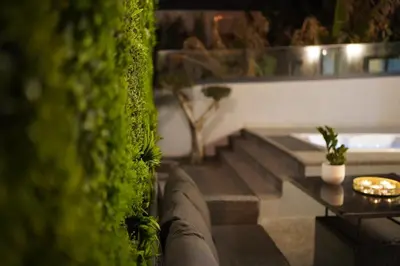 a person is standing on a set of stairs with green plants at Sunset Avenue for couple w/ jacuzzi spa hot water in Paul do Mar