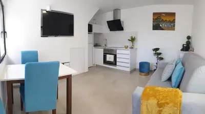 a living room with a couch and a table at Sunset Avenue for couple w/ jacuzzi spa hot water in Paul do Mar
