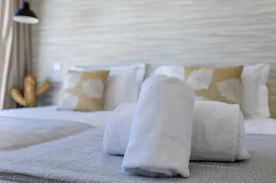 a bed with white towels on top of it at Villa Back Loop in Sagres