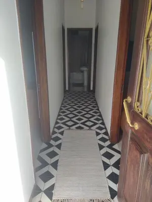 a hallway with a tile floor and a stairway at Bus Stop House 84 in Funchal