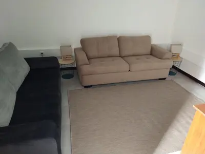 a living room with a couch and a rug at Bus Stop House 84 in Funchal