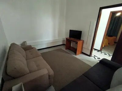 a living room with a couch and a television at Bus Stop House 84 in Funchal
