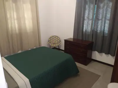 a room with a bed and a chair and a dresser at Bus Stop House 84 in Funchal