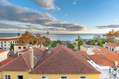 a view of roofs of houses and the ocean at Bela Sao Tiago 36 in Funchal
