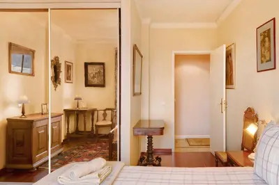 a bedroom with a bed and a desk in a room at Bela Sao Tiago 36 in Funchal