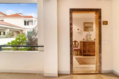 a door leading to a balcony with a dresser at Bela Sao Tiago 36 in Funchal