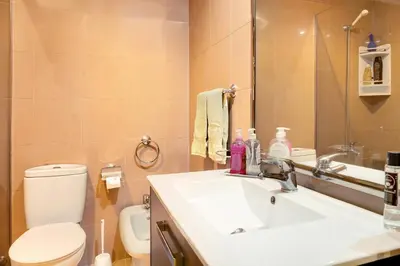 a bathroom with a sink and a toilet and a mirror at Bela Sao Tiago 36 in Funchal