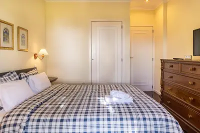 a bedroom with a bed with two towels on it at Villa Echium T2 in Caniço