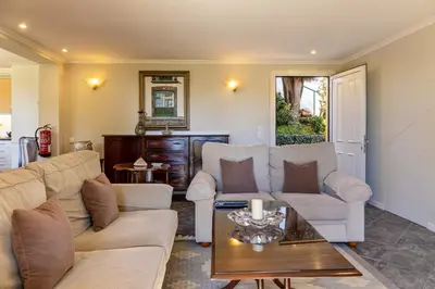 a living room with two couches and a coffee table at Villa Echium T1 in Caniço