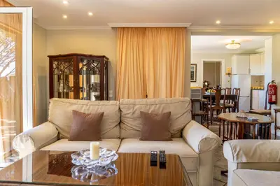 a living room with a couch and a table at Villa Echium T1 in Caniço