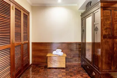 a sauna with wood paneling and a table with towels at Villa Echium T1 in Caniço