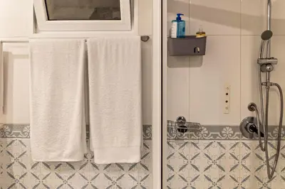 two towels are hanging in a bathroom at Villa Echium T1 in Caniço
