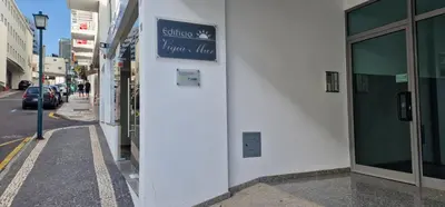 a white building with a sign on the side of it at Ocean Pearl Apartment V in Funchal