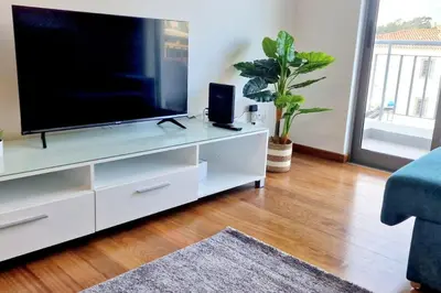 a living room with a television on a white entertainment center at Ocean Pearl Apartment V in Funchal