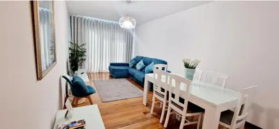 a living room with a blue couch and a table at Ocean Pearl Apartment V in Funchal