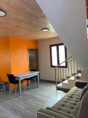 an office with a table and chairs and a staircase at casa caminho da praia in Porto da Cruz