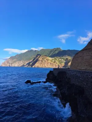 a large body of water with mountains in the background at casa caminho da praia in Porto da Cruz
