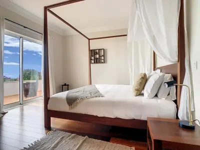 a bedroom with a large bed and a desk and window at Ocean 59 by LovelyStay in Funchal