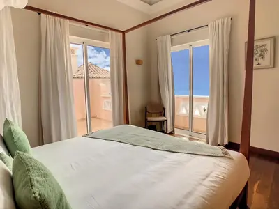 a bedroom with a bed with a view of the ocean at Ocean 59 by LovelyStay in Funchal