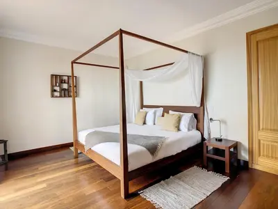 a bedroom with a canopy bed and a wooden floor at Ocean 59 by LovelyStay in Funchal