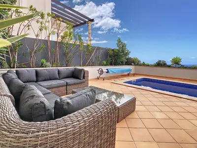 a living room with a couch and a swimming pool at Ocean 59 by LovelyStay in Funchal