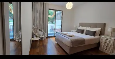 a bedroom with a large bed and a balcony at Ocean Pearl Apartment K in Funchal